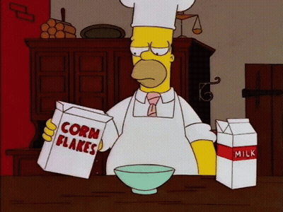 Homer Simpson Is Reading A Box Of Corn Flakes GIF