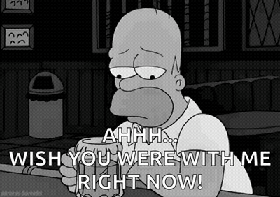 Homer Simpson Is Sitting At A Bar Holding A Beer And Saying " Ahhh Wish You Were With Me Right Now " GIF