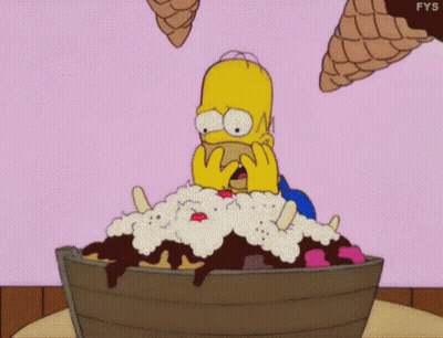 Homer Simpson Is Sitting In A Bucket Of Ice Cream With Ice Cream Cones Flying Around Him . GIF