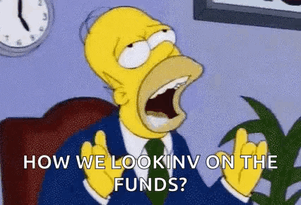 Homer Simpson Is Sitting In A Chair With His Mouth Open And Looking At The Camera . GIF
