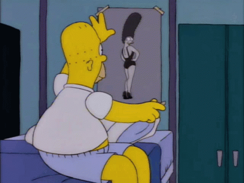 Homer Simpson Is Sitting On A Bed Looking At A Picture Of Marjorie GIF