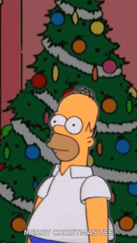 Homer Simpson Is Standing In Front Of A Christmas Tree With The Words Merry Christmas Tee Below Him GIF