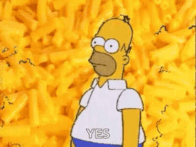 Homer Simpson Is Standing In Front Of A Pile Of Macaroni Cheese . GIF