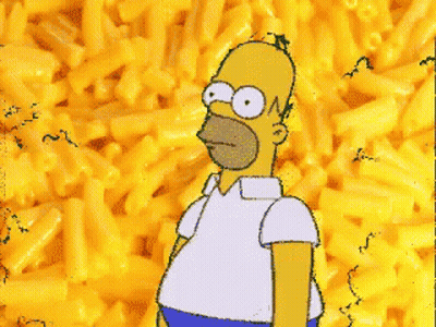 Homer Simpson Is Standing In Front Of A Pile Of Macaroni Cheese GIF