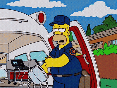 Homer Simpson Talking On Cell Phone In Front Of Ambulance GIF