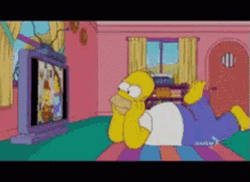 Homer Watching Television Lying In The Floor GIF