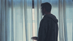 Hoodie Man Looking Out The Window GIF