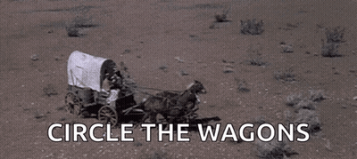 Horse Pulling Covered Wagon In Desert GIF