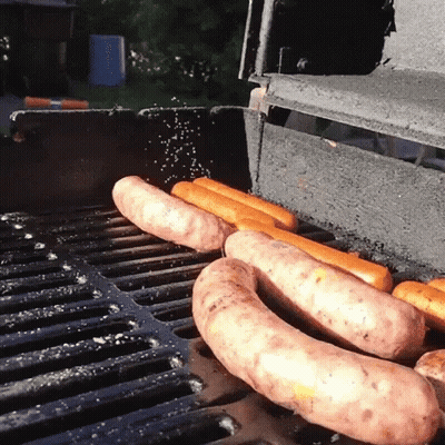 Hot Dogs Cooking On Grill With Salt Sprinkled GIF