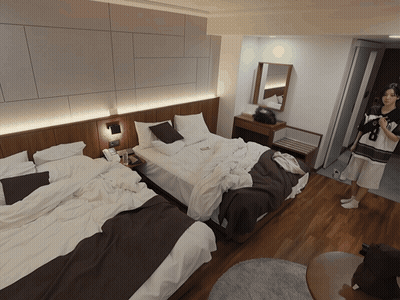 Hotel Room With Two Beds And Person In Doorway GIF