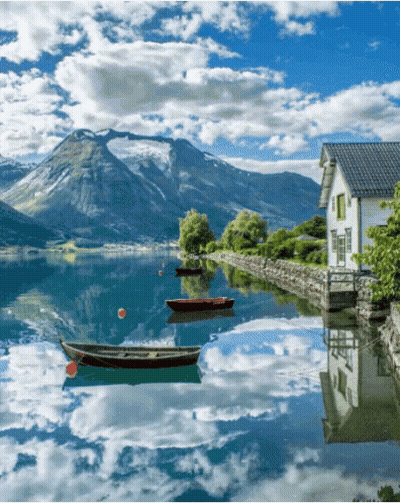 House On Lake Shore With Boats GIF