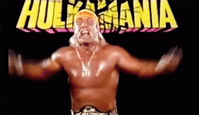 Hulk Hogan Is A Wrestler With His Arms Outstretched In Front Of A Hulkmania Logo . GIF