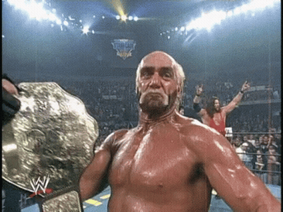 Hulk Hogan Is Holding A World Heavyweight Wrestling Championship Belt In A Ring . GIF