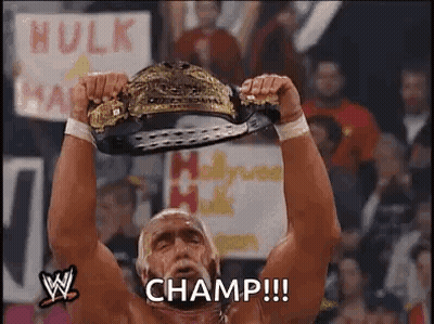 Hulk Hogan Is Holding A Wrestling Championship Belt Over His Head In Front Of A Crowd . GIF