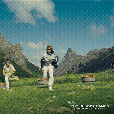 Hunger Games Poster Two People Running Through Field GIF