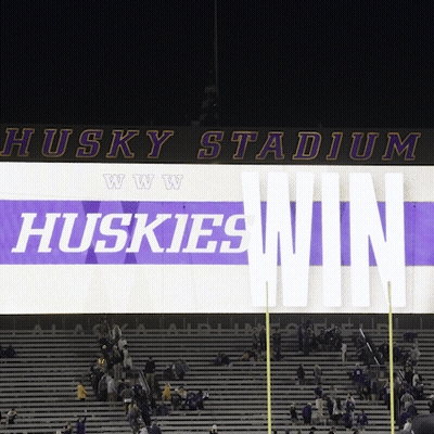 Huskies Win Sign Lit Up In Stadium At Night GIF