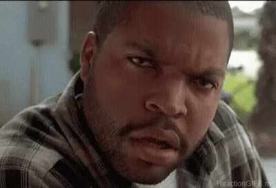Ice Cube Is Wearing A Plaid Shirt And Looking At The Camera With A Serious Look On His Face . GIF