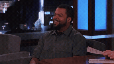 Ice Cube Smiling At Table With Paper GIF