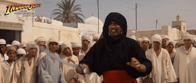 Indiana Jones Poster Man Holding Sword In Front Of Crowd GIF