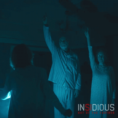 Insidious Out Of The Further Poster Man And Woman In Dark Room GIF