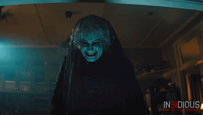 Insidious Out Of The Further Poster Man And Woman In Dark Room GIF