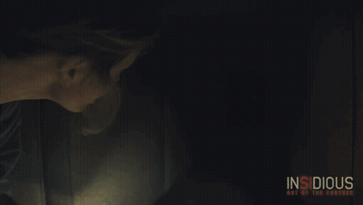 Insidious Poster Woman Holding Lighter In Dark Room GIF
