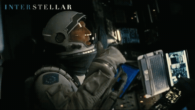 Interstellar Astronaut Looking At Laptop GIF