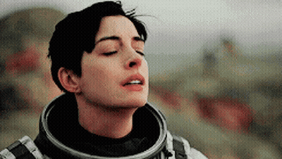 Interstellar Man In Space Suit Looking At Laptop GIF