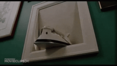 Iron In Picture Frame On Green Wall GIF