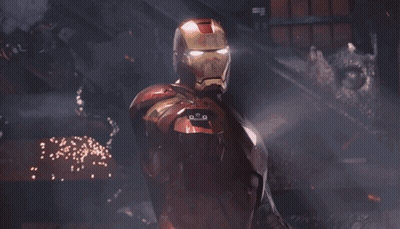 Iron Man Is Holding A Red Light Beam In His Hand . GIF