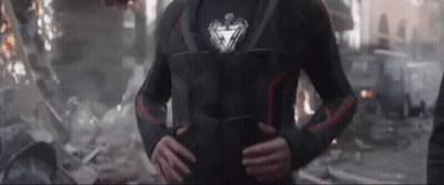 Iron Man Standing In Destroyed City Hands On Hips GIF