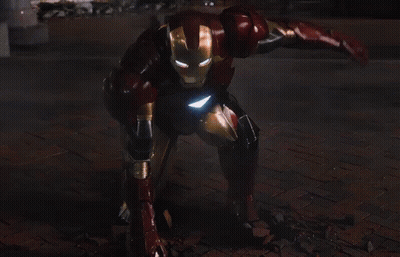 Iron Man Standing In Front Of City At Night GIF