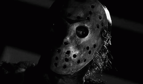 It Is A Black And White Photo Of A Person Wearing A Hockey Mask . GIF