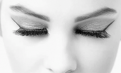 It Is A Black And White Photo Of A Woman 'S Eyes With Long Eyelashes . GIF