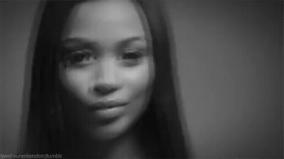 It Is A Black And White Photo Of A Woman 'S Face . GIF
