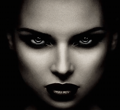 It Is A Black And White Photo Of A Woman 'S Face With Dark Lipstick And Evil Eyes . GIF