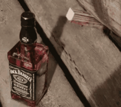 Jack Daniel's Bottle On Wooden Table GIF