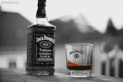 Jack Daniel's Whiskey Bottle And Glass On Wooden Table GIF