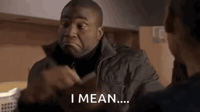 Jacketed Man Talking Making Face In Kitchen GIF