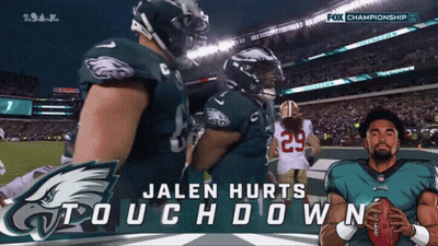 Jalen Hurts Holding Football In Front Of Fox Championship Banner GIF