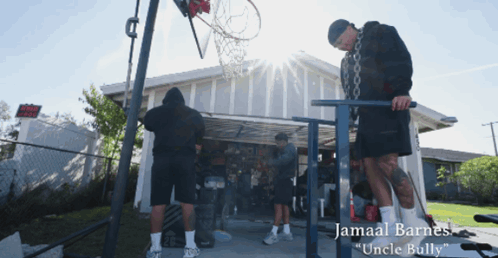 Jamaal Barnes Standing In Front Of Garage With Basketball Hoop GIF