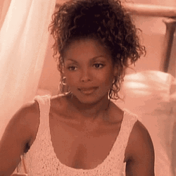 Janet Jackson Smiling While Sitting GIF