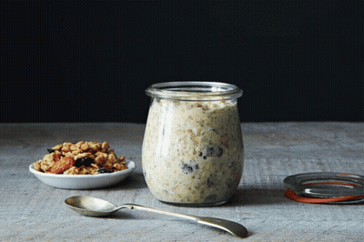 Jar Of Oatmeal Next To Bowl Of Granola And Spoon GIF