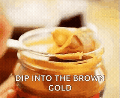 Jar Of Peanut Butter With Spoon Dip Into The Brown Gold GIF