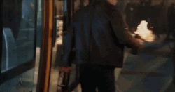 Jason Bourne Tossing A Bottle On Fire GIF