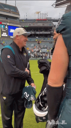Jason Kelce Hugging A Man GIF