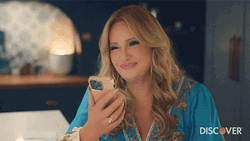 Jennifer Coolidge Smiling While Holding Phone GIF