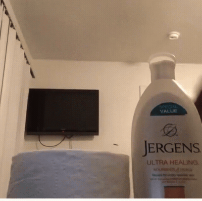 Jergens Ultra Healing Lotion In Front Of TV GIF