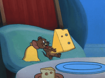 Jerry From Tom And Jerry Is Holding A Large Piece Of Cheese GIF