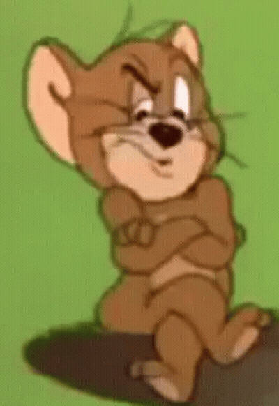 Jerry From Tom And Jerry Is Sitting On A Rock With His Arms Crossed And Making A Funny Face . GIF